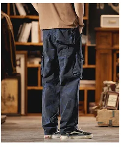 Detail view of retro camouflage cargo pants showing back pockets and loose straight leg fit