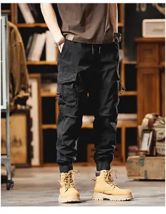 Close-up view of premium black multi-pocket cargo jogger pants for men's street style.