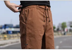 Detail of men's vintage brown cargo shorts with drawstring waist and pocket label
