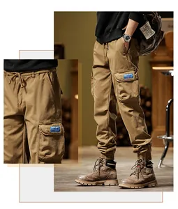 Detailed view of men's vintage khaki cargo pants featuring large side pockets and drawstring