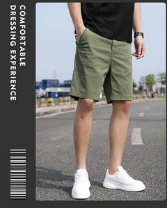Detailed lifestyle view of men's vintage olive green cargo shorts in a loose casual fit