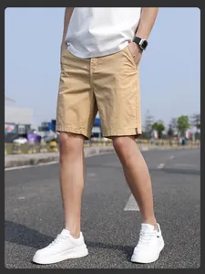 Detailed macro shot of khaki men's summer casual chino shorts on model in outdoor setting