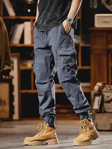 Men's stylish multi-pocket cargo pants in dark blue with elastic cuffs and drawstring.