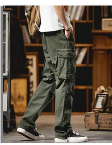 Side view of green cargo pants with large utility pockets in an industrial setting