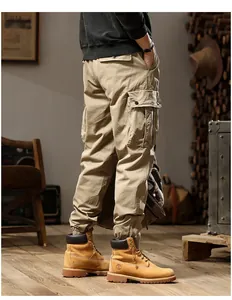 Detailed side view of khaki cargo pants with multiple pockets and elastic cuffs