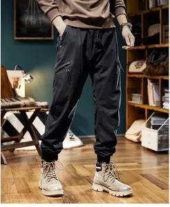 Close-up of black men's outdoor cargo jogger pants with multi-pocket design