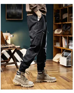 Side view detail of men's black outdoor cargo joggers with cuffed ankles