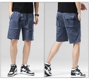 Close-up detail view of stylish blue cotton cargo shorts for men featuring elastic drawstring waist