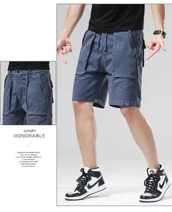 Detailed view of men's loose slate blue cargo shorts featuring functional side pockets and ties