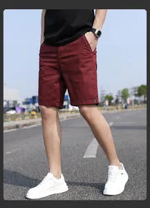 Detail of men's vintage burgundy relaxed fit cargo shorts in a casual outdoor setting