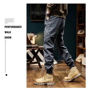 Side view of gray men's cargo jogger pants with elasticized cuffs in indoor setting.