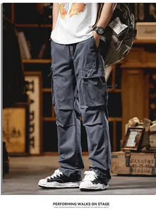 Detail view of grey straight-leg cargo pants with multi-pockets and drawstring details
