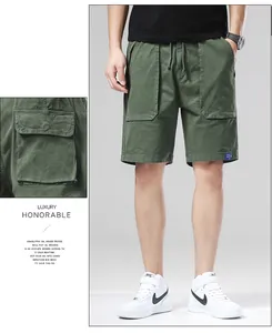 Detailed view of men's olive green cargo shorts featuring a functional side pocket.