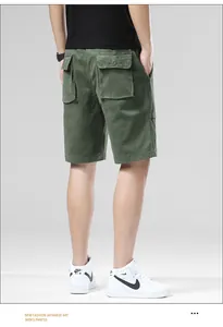 Detailed back view of men's olive green loose cargo shorts featuring flap pockets