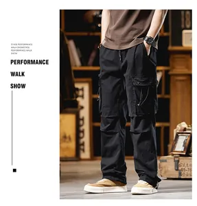 Detail view of men's black multi-pocket straight-leg cargo pants in a high street style