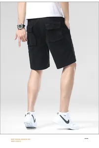 Back view of men's loose black summer cargo shorts with large utility flap pockets