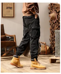 Men's black cargo pants with side pockets and elastic cuffs in a retro studio