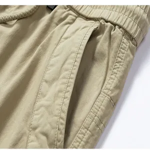 Macro view of men's khaki cargo pants featuring elastic waistband and side pocket details
