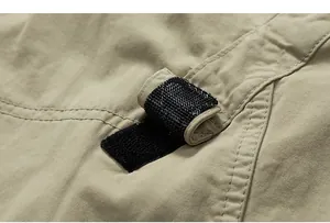 Detailed macro view showing adjustable black velcro strap on durable khaki cotton cargo pants