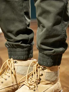 Detailed view of men's olive green outdoor mountain cargo joggers with fleece lining