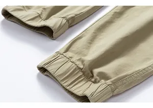 Close-up detail of elasticated ankle cuffs on men's khaki cotton cargo jogger pants.
