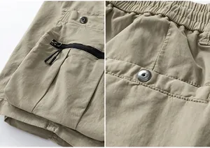 Close-up detail of khaki cargo shorts showing functional zipper pocket and rugged fabric texture.