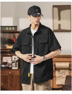 Detailed view of a men's Japanese style black cargo short sleeve shirt with utility pockets