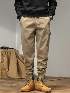 Men's khaki cargo jogger pants with drawstring waist and elastic cuffs in casual setting