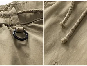 Detailed view of khaki high street cargo pants showing elastic waist, D-ring, and drawstring