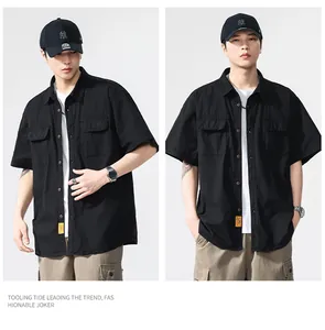 Professional detail view of a black short-sleeve cargo shirt with multi-pocket design