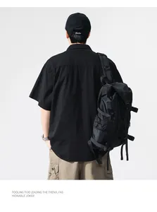 Back view of men's oversized black short-sleeved work shirt in Japanese retro style