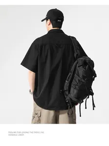 Rear view of a men's black Japanese style short-sleeve cargo shirt for street fashion