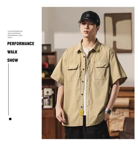 Casual khaki short-sleeved work shirt with dual chest pockets and button-down front.