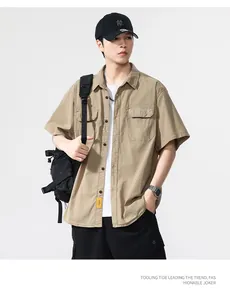 Detail view of men's khaki short-sleeved retro workwear shirt featuring utility pockets