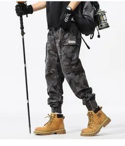 Side view of men's camouflage cargo jogger pants with large pockets and hiking gear