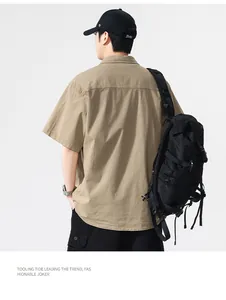 Detailed back view of a khaki short-sleeve Japanese style work shirt with a black backpack