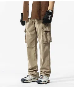 Detail of men's khaki cargo pants with vintage multi-pocket design and loose fit style.