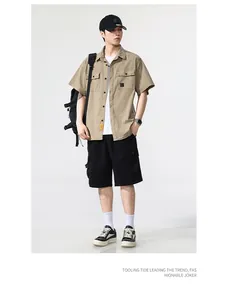 Full view of men's khaki short-sleeved cargo shirt styled with black shorts