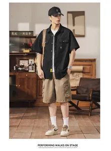 Male model wearing a black cargo short-sleeve shirt with multi-pockets in a retro setting