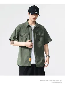 Professional male model wearing vintage olive green short sleeve work shirt with cargo pockets