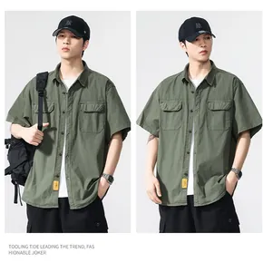Detail view of a men's army green cargo short-sleeved shirt with double chest pockets.