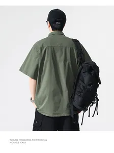 Back view of a men's olive green cargo short-sleeve shirt in vintage Japanese style