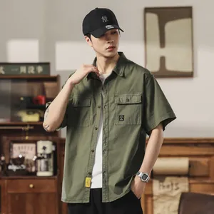 Men's retro olive green short-sleeve work shirt with multi-pockets in casual setting