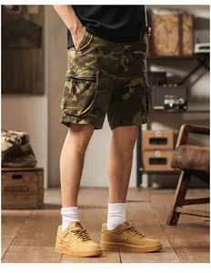 Men's camouflage cargo shorts featuring multi-pocket design in a vintage studio setting