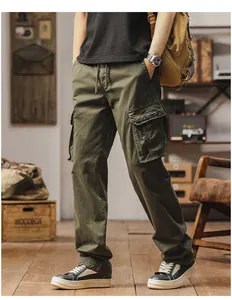 Detail of men's olive green cargo pants featuring functional multi-pocket design