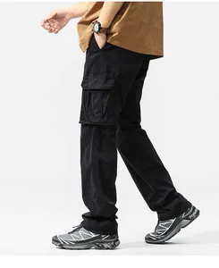 Close-up of men's black retro cargo pants featuring heavy-duty multi-pocket design on model