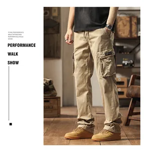 Detail view of men's khaki multi-pocket cargo pants styled in a vintage room setting