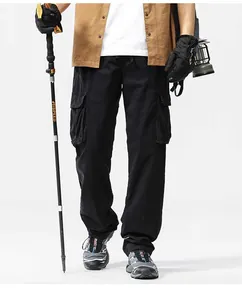 Men's retro multi-pocket heavyweight cargo pants shown in an outdoor hiking style