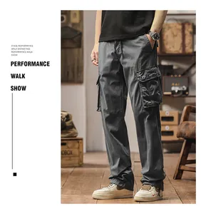 Grey loose fit multi-pocket cargo pants for men shown in a vintage studio setting