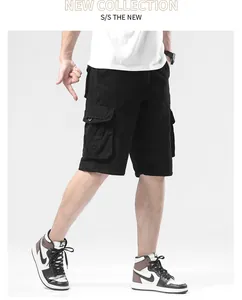 Men's loose fit black cargo shorts with multi-pockets shown from a side view on model.